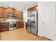 Kitchen with wooden cabinets, stainless steel appliances and a white entry door at 3897 Lake Sanctuary Way, Atlanta, GA 30349