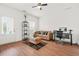 Cozy living room with tan leather sofa, workstation, and access to outdoor patio at 3897 Lake Sanctuary Way, Atlanta, GA 30349