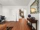 Inviting living space with hardwood floors, modern decor, and arched doorway to the staircase at 3897 Lake Sanctuary Way, Atlanta, GA 30349