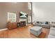 Bright living room with fireplace, hardwood floors, and large windows, offering a comfortable space at 3897 Lake Sanctuary Way, Atlanta, GA 30349