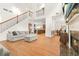 Spacious living room featuring a fireplace, hardwood floors, and modern decor, with staircase at 3897 Lake Sanctuary Way, Atlanta, GA 30349