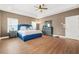 Spacious main bedroom with ample natural light and tray ceilings, and beautiful floors at 3897 Lake Sanctuary Way, Atlanta, GA 30349