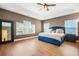 Spacious main bedroom with ample natural light and tray ceilings, and beautiful floors at 3897 Lake Sanctuary Way, Atlanta, GA 30349