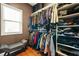 Spacious walk-in closet with organized shelving and window for great natural light at 3897 Lake Sanctuary Way, Atlanta, GA 30349