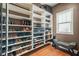 Spacious walk-in closet with organized shelving and window for great natural light at 3897 Lake Sanctuary Way, Atlanta, GA 30349