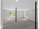 Spacious basement with two windows, carpet floors, and black support poles at 4453 Autumn Glo Ct Ct, Douglasville, GA 30135