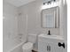 Well-lit bathroom featuring a vanity with a black faucet, a mirror, and a shower and tub combination at 4453 Autumn Glo Ct Ct, Douglasville, GA 30135