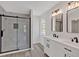 Bathroom featuring a glass shower and dual sinks with modern fixtures at 4453 Autumn Glo Ct Ct, Douglasville, GA 30135