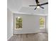 Open, light filled bedroom featuring gray floors, neutral walls, and views to the outdoors at 4453 Autumn Glo Ct Ct, Douglasville, GA 30135
