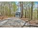 Long driveway leads to a two-story home surrounded by a lush forest at 4453 Autumn Glo Ct Ct, Douglasville, GA 30135