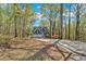 View of two-story home with a two-car garage surrounded by a wooded area at 4453 Autumn Glo Ct Ct, Douglasville, GA 30135