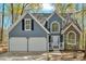Close-up of a two-story home with a stone facade and an attached garage at 4453 Autumn Glo Ct Ct, Douglasville, GA 30135