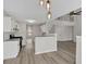 Open concept living space with stainless steel appliances, eat-in breakfast bar, stairs and hardwood floors at 4453 Autumn Glo Ct Ct, Douglasville, GA 30135