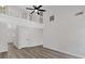 High-ceilinged living area with hardwood floors, a ceiling fan, and natural light streaming through the windows at 4453 Autumn Glo Ct Ct, Douglasville, GA 30135