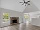 Living room with a fireplace, hardwood floors, a ceiling fan, and natural light streaming through the windows at 4453 Autumn Glo Ct Ct, Douglasville, GA 30135