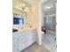 Bathroom with white vanity, shower over tub, view into bedroom and neutral color scheme at 7440 Banks Mill Rd, Douglasville, GA 30135