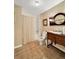 Bathroom featuring wallpaper, tiled floors, single vanity and a shower with curtain at 7440 Banks Mill Rd, Douglasville, GA 30135