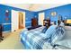 Bright blue bedroom with a bed, a ceiling fan, and traditional furnishings at 7440 Banks Mill Rd, Douglasville, GA 30135