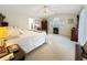 Spacious main bedroom with a vaulted ceiling, neutral carpet, a sitting area, and ensuite bathroom access at 7440 Banks Mill Rd, Douglasville, GA 30135