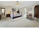 Spacious main bedroom with a vaulted ceiling, neutral carpet, a sitting area, and ensuite bathroom access at 7440 Banks Mill Rd, Douglasville, GA 30135