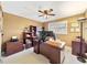 Spacious office with a large desk, filing cabinets, a ceiling fan, and natural light at 7440 Banks Mill Rd, Douglasville, GA 30135