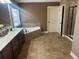 Bathroom featuring double sink vanity, tile floor, garden tub, and walk-in glass shower at 1210 Del Mar Club Dr, Dacula, GA 30019