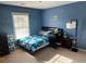 Blue bedroom featuring a twin bed, and large window that allows for natural light at 1210 Del Mar Club Dr, Dacula, GA 30019