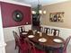 Formal dining room with seating for eight, chandelier, and decorative accents at 1210 Del Mar Club Dr, Dacula, GA 30019