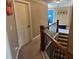 Hallway features a stained wood railing, plush carpet, and access to rooms with paneled doors at 1210 Del Mar Club Dr, Dacula, GA 30019