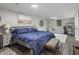 Inviting bedroom features a plush blue comforter, dark wood floors, and bright natural light at 2810 Dunnington Cir, Chamblee, GA 30341