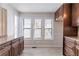 Bright eat-in kitchen featuring light-colored floors, plenty of light and dark wood cabinets with granite counters at 4809 Burlington Nw Ct, Acworth, GA 30102