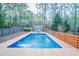 Outdoor pool surrounded by wooden decking and fencing, offering a private and refreshing retreat at 4809 Burlington Nw Ct, Acworth, GA 30102