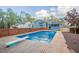 Backyard pool with a diving board surrounded by a wood fence and trees, offering a private oasis at 4809 Burlington Nw Ct, Acworth, GA 30102