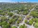 Aerial view showcasing the home's location within a lush, green neighborhood, with the city skyline in the distance at 559 Robinson Se Ave, Atlanta, GA 30315