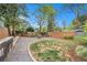 Fenced backyard featuring a gravel pathway, fire pit, and green grass at 559 Robinson Se Ave, Atlanta, GA 30315