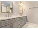 Bathroom with dual vanity, gray cabinets, and modern fixtures at 559 Robinson Se Ave, Atlanta, GA 30315
