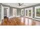 Bedroom with hardwood floors, neutral paint, ceiling fan, and French doors to a deck at 559 Robinson Se Ave, Atlanta, GA 30315