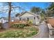 Backyard view of home with deck, gravel pathway, storage shed, and green lawn at 559 Robinson Se Ave, Atlanta, GA 30315