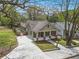Eye-level view of a well-manicured lawn, concrete driveway, and a home with a welcoming front porch at 559 Robinson Se Ave, Atlanta, GA 30315