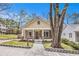 Charming home featuring a welcoming front porch and beautifully landscaped front yard under a clear, blue sky at 559 Robinson Se Ave, Atlanta, GA 30315