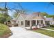 Inviting exterior showcasing manicured lawn, a driveway, and a charming porch; the epitome of suburban elegance at 559 Robinson Se Ave, Atlanta, GA 30315