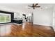Spacious living room seamlessly blends with the modern kitchen, complemented by gleaming hardwood floors and bright windows at 559 Robinson Se Ave, Atlanta, GA 30315