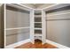Walk-in closet with built-in shelving and hardwood floors at 559 Robinson Se Ave, Atlanta, GA 30315