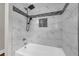 Bathroom featuring marble tile tub, rain shower, and accent tiles at 111 Leathers Circle Nw, Atlanta, GA 30314