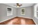 Bright bedroom featuring hardwood floors, ceiling fan, and natural lighting at 111 Leathers Circle Nw, Atlanta, GA 30314