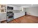 Bright kitchen with white cabinets, stainless steel appliances, and durable laminate flooring at 111 Leathers Circle Nw, Atlanta, GA 30314