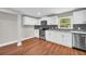 Updated kitchen featuring stainless steel appliances, granite countertops, and white cabinets at 111 Leathers Circle Nw, Atlanta, GA 30314