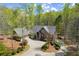 Aerial view showcasing the home's layout, driveway, and expansive wooded lot at 208 Greenhill Dr, Dallas, GA 30157