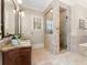 Beautiful bathroom featuring double vanities, glass shower, and modern fixtures at 208 Greenhill Dr, Dallas, GA 30157