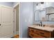 Bathroom with wood vanity and marble countertop, complemented by sleek black fixtures at 208 Greenhill Dr, Dallas, GA 30157